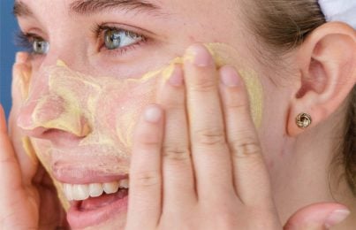 a woman using a face scrub