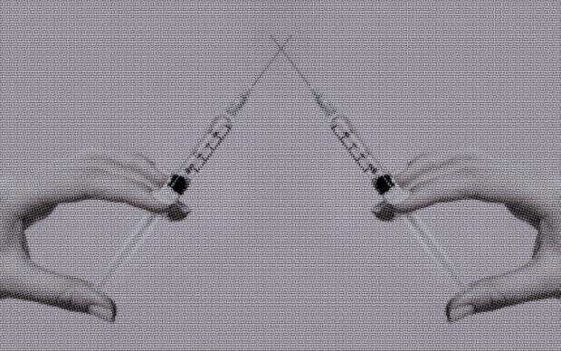 two hands holding cortisone injections
