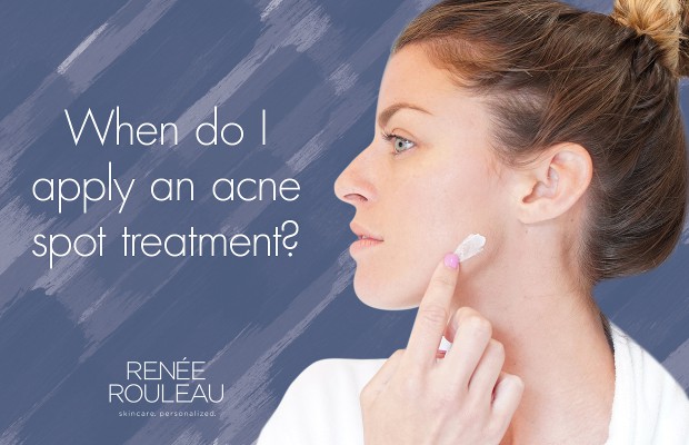 a woman applying spot treatment on her acne