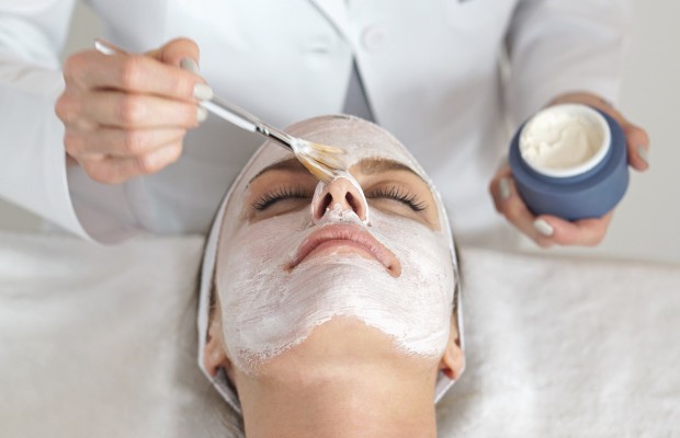 esthetician applying a peel on a woman's face