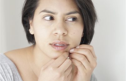 a woman picking at her skin
