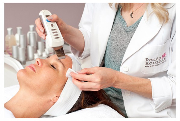 A woman getting a facial exfoliation