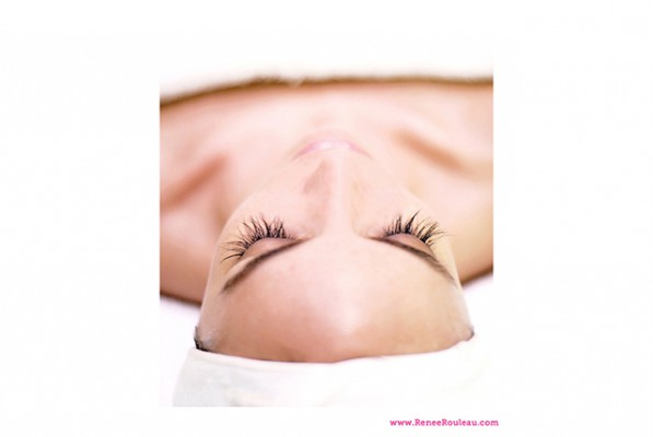 A woman laying on a table with a towel on her body