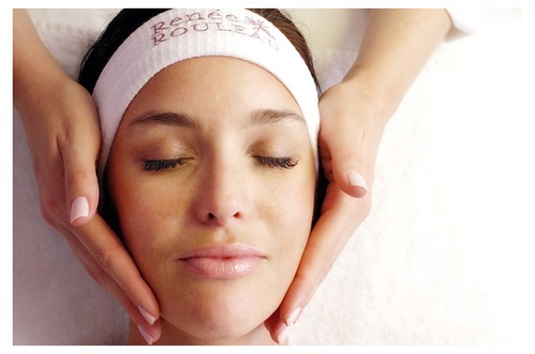 a woman's face getting examined