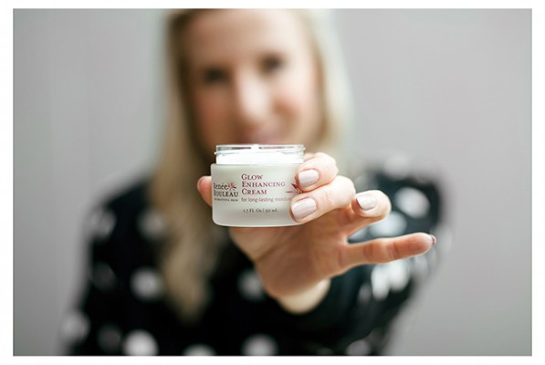 Renee Rouleau holding her glow enhancing cream