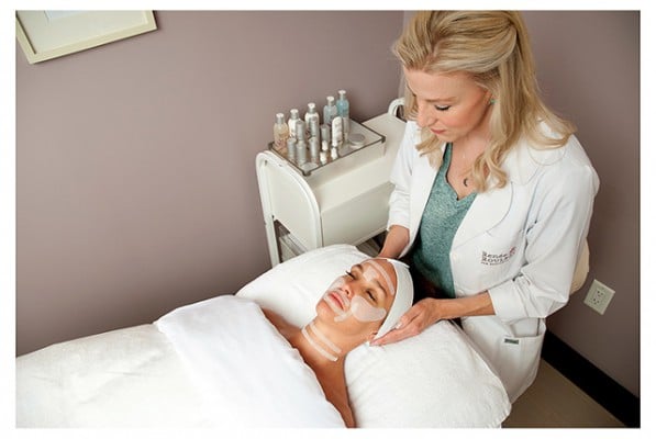 Renee Rouleau with a client laying on the bed