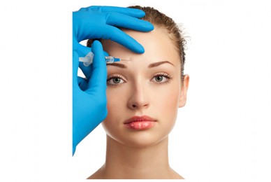 a woman getting a botox injection in her forehead