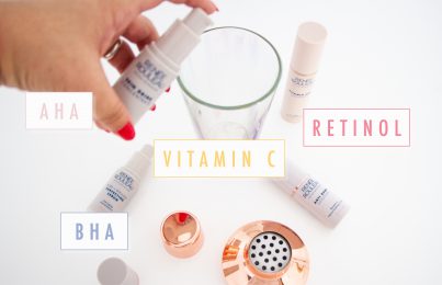 Hand mixing skincare ingredients into a glass