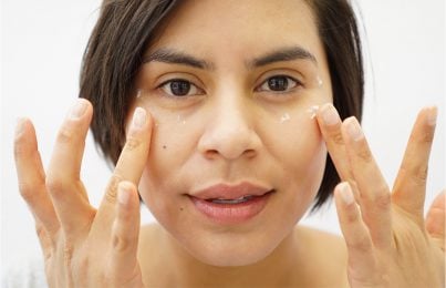 A woman applying Renee Rouleau under eye cream