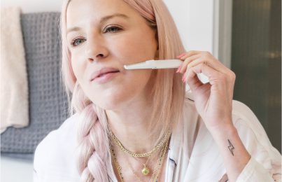 a woman shaving her face
