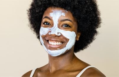 a woman with facial cream on her face
