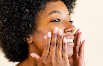 a woman doing her facial skincare