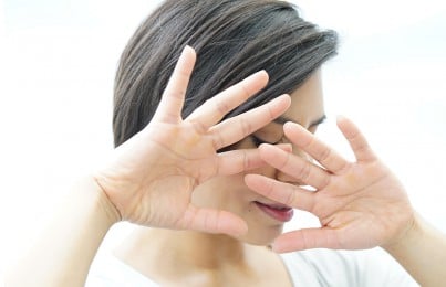 a woman hiding her face