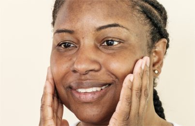 a woman touching her face