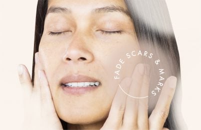 a woman rubbing her face with her eyes closed