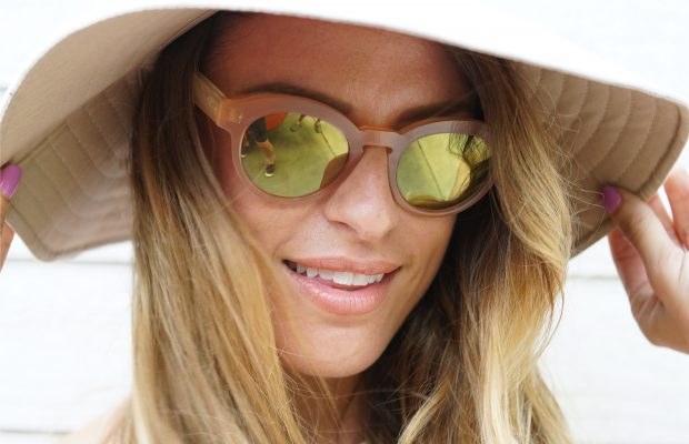 a woman wearing shades and a hat