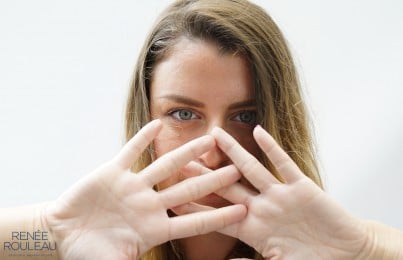 woman covering her face with her hands