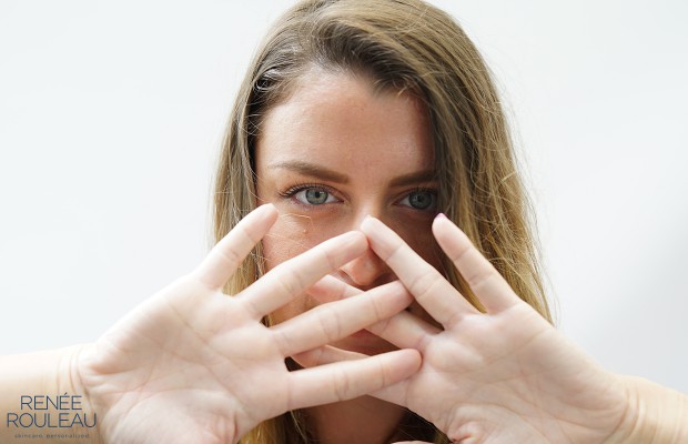 woman covering her face with her hands