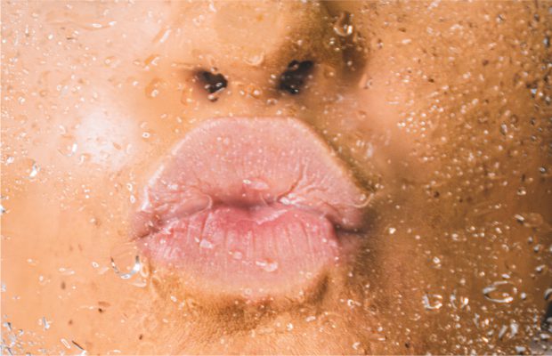 Woman kissing glass