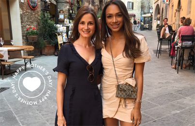 a woman and her daughter standing in the street