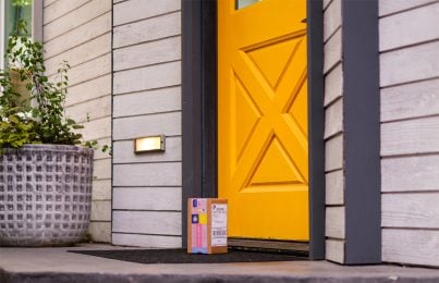 a skincare package placed at a house door