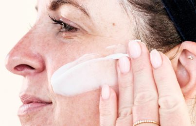woman applying silicon containing cream on her face