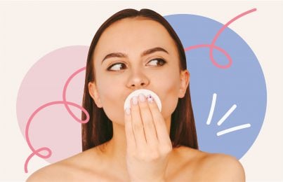 woman holding a cotton pad on her lips