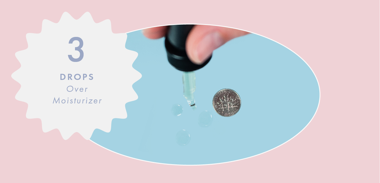 hand with a dropper and three drops of face oil next to dime
