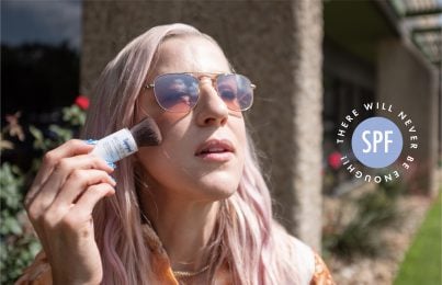 Renee Rouleau applying sun screen over her makeup