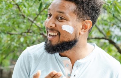 a man with sunscreen on his cheek