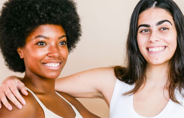 two women can be seen standing with each other in a friendly manner
