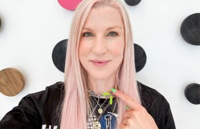 Renee Rouleau is pointing at her neck indicating the neck tightening procedure