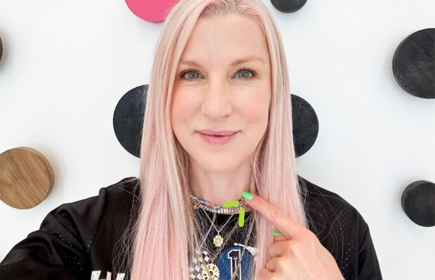 Renee Rouleau is pointing at her neck indicating the neck tightening procedure