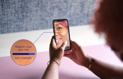 Woman scanning her face with a skincare AI